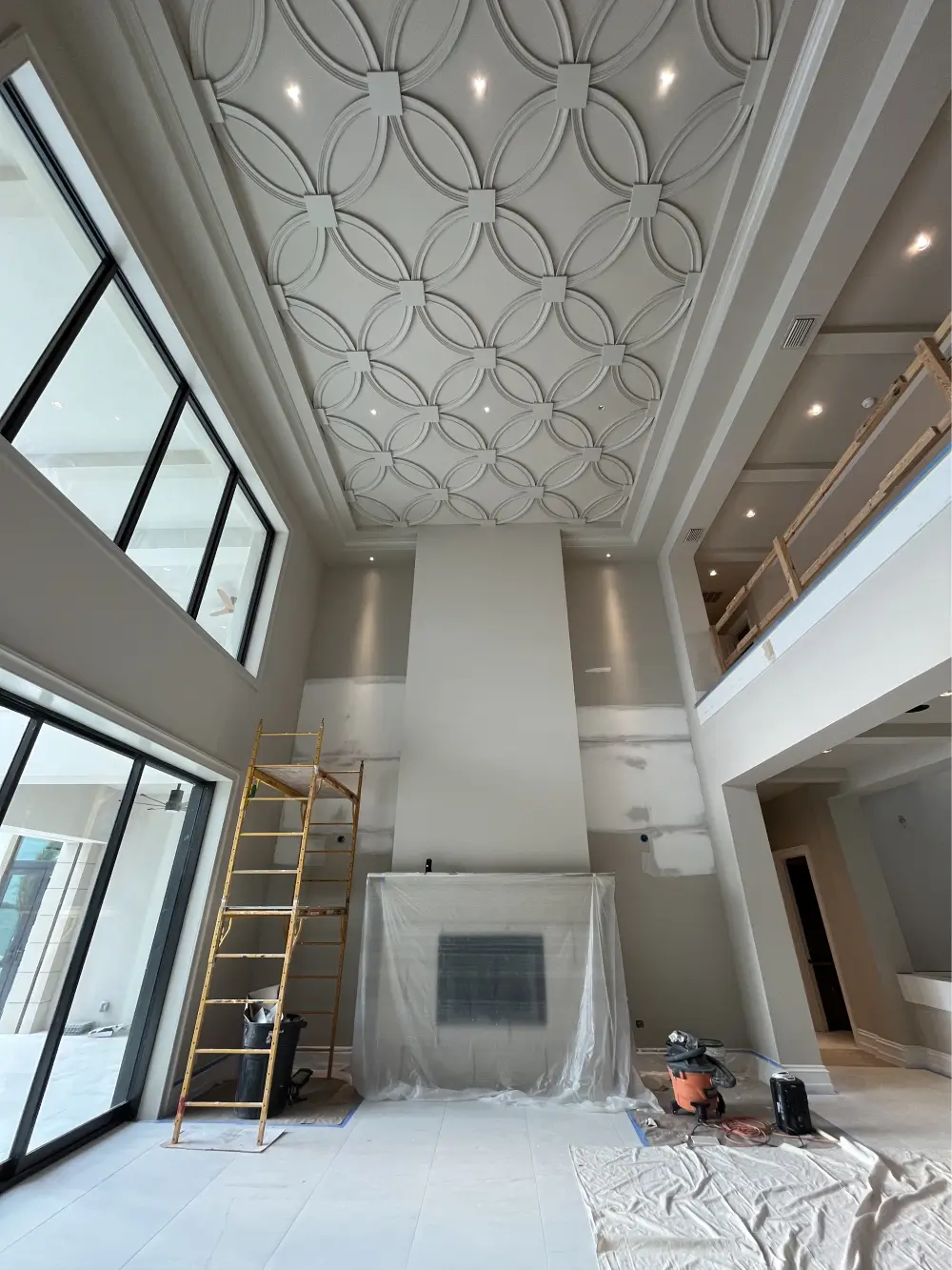 luxury coastal living room interior design in fort myers featuring custom coffered ceiling detail