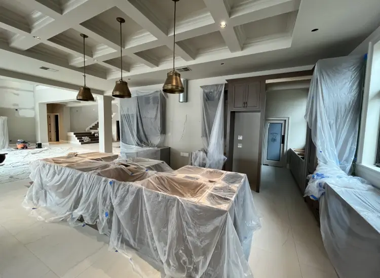 modern coastal kitchen interior design with coffered ceiling brass pendant lighting and cabinetry new construction