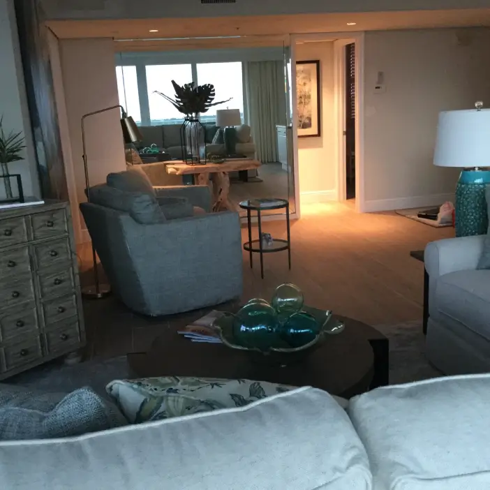 Coastal contemporary living-room interior design in Fort Myers featuring layered seating, neutral tones, and soft ambient lighting